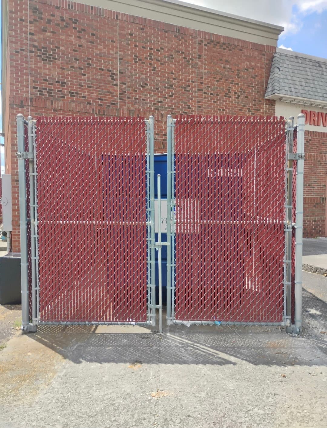 Red privacy slat chain link double swing gate