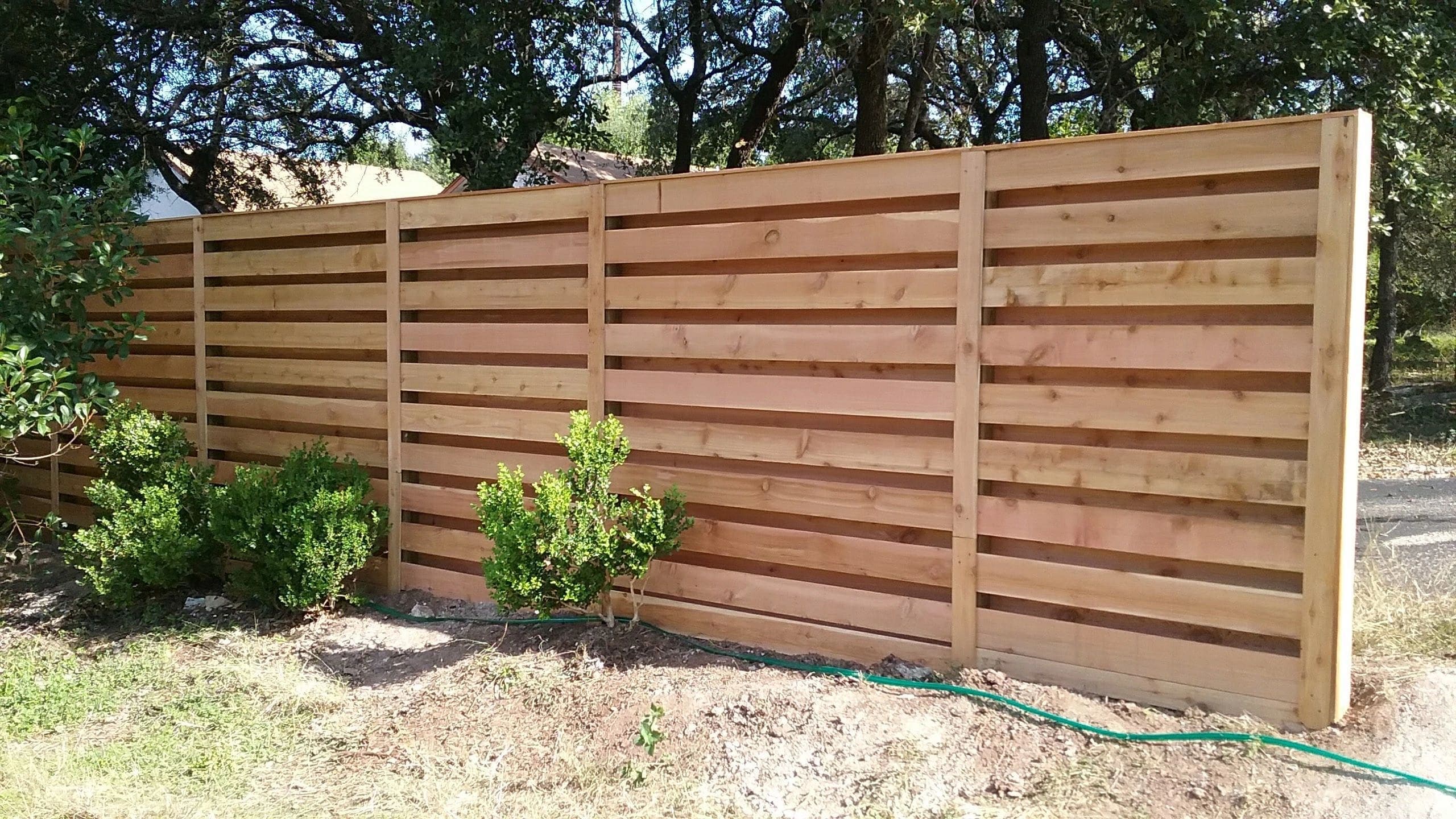 Horizontal privacy fence with slat spacing