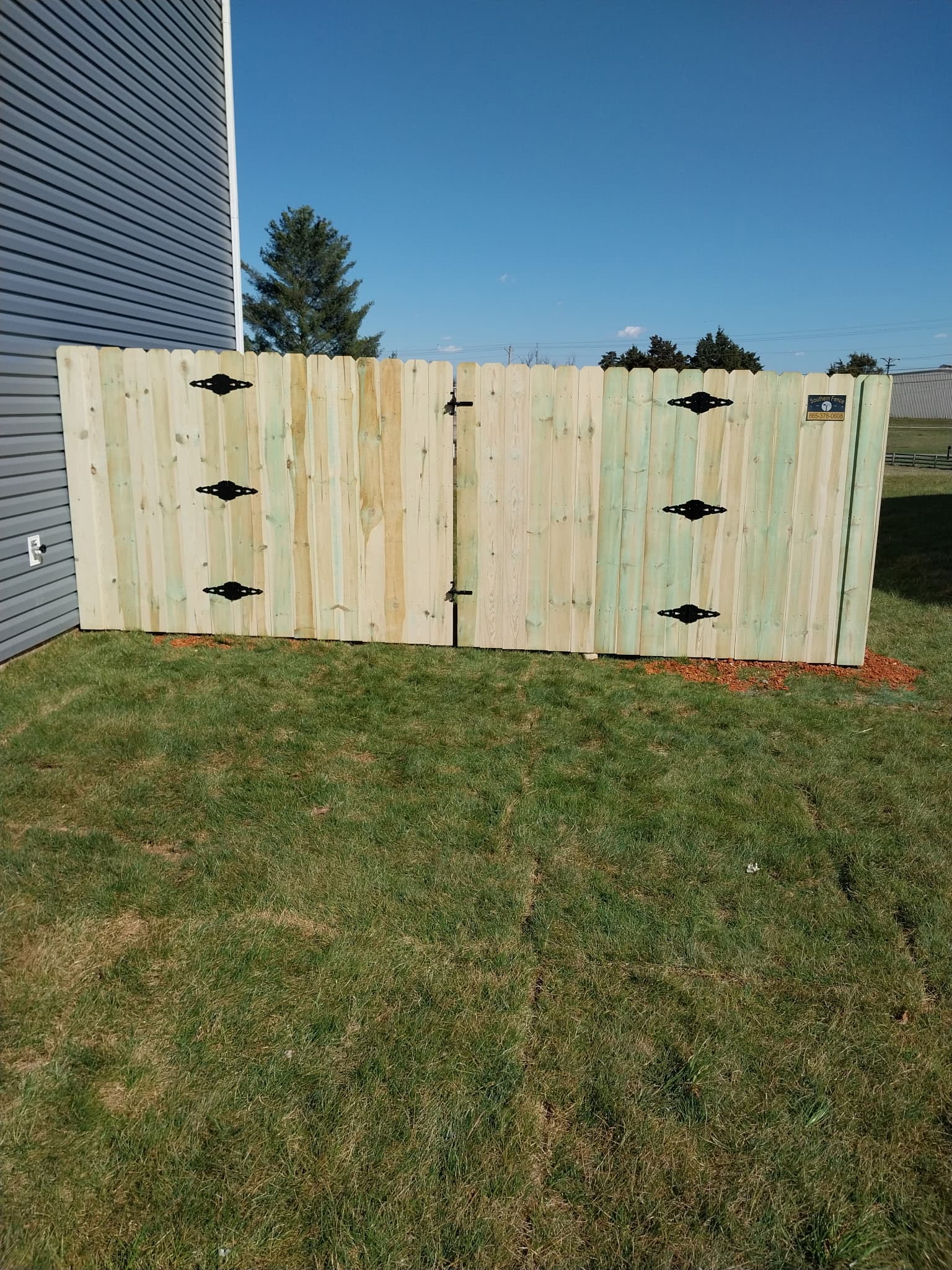 Natural wood privacy fence with vertical boards