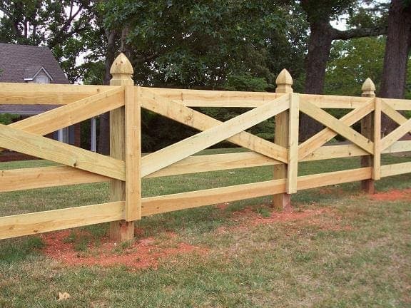 Wood cross buck rail fence with decorative design